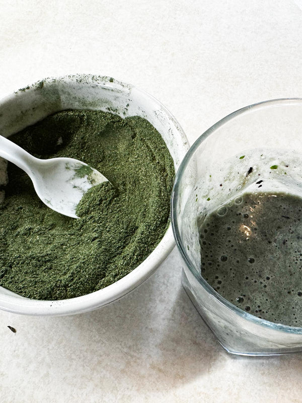 Two bowls with green powder and a liquid mixture on a light background